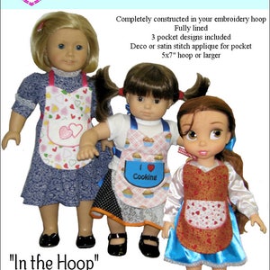 May include: Three dolls wearing red, pink, and blue aprons with embroidered hearts, cupcakes, and the words "I love Cooking". The aprons are machine embroidered and designed for a 5x7 inch hoop or larger. "In the Hoop" Valentines Apron.
