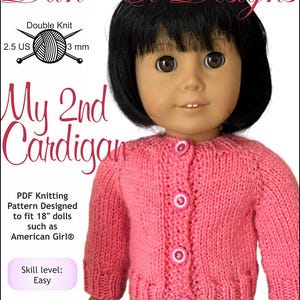 May include: A pink knitted cardigan with white buttons, designed for 18-inch dolls. The cardigan is shown on a doll with black hair and brown eyes. The text "My 2nd Cardigan" is written in pink and white letters. The text "Skill level: Easy" is written in purple and white letters. The text "Dan-El Designs" is written in black letters. The text "Double Knit 2.5 US 3 mm" is written in black letters. The text "PDF Knitting Pattern Designed to fit 18" dolls such as American Girl®" is written in black letters. The text "Copyright © 2024 Dan-El Designs" is written in black letters.