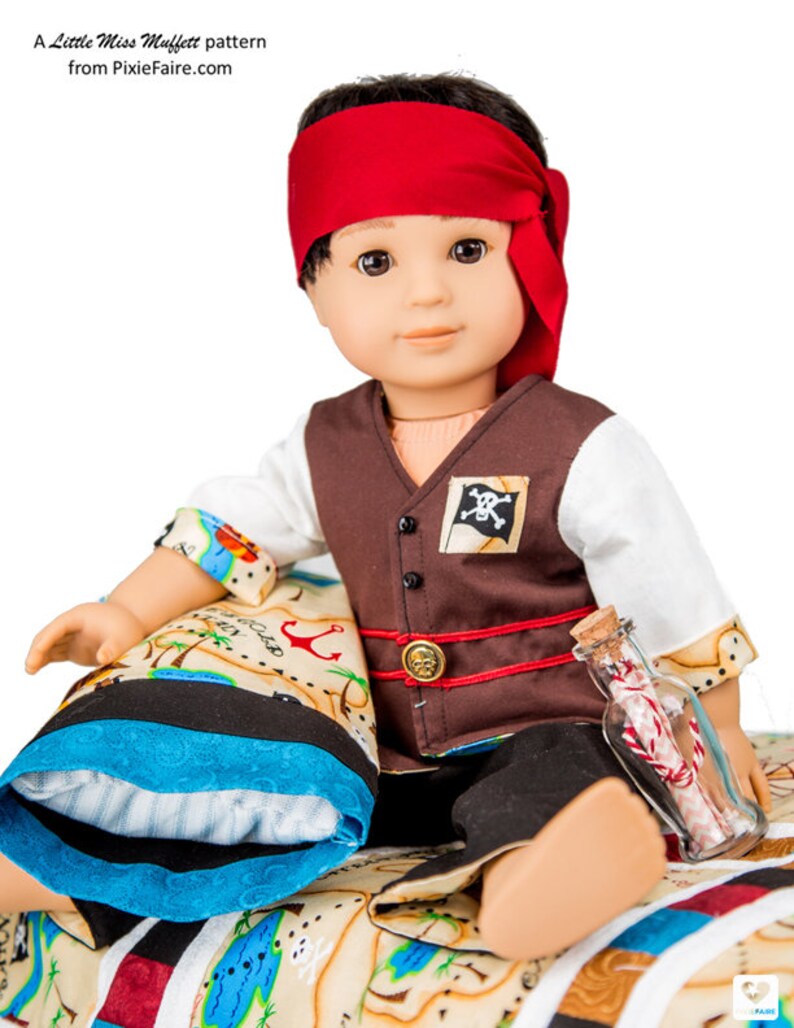 May include: A doll dressed as a pirate, wearing a brown vest with a skull and crossbones patch, a red bandana, and black pants. The doll is holding a glass bottle with a rolled-up piece of paper inside. The doll is sitting on a bed with a blue and white pillow and a map printed on the fabric.