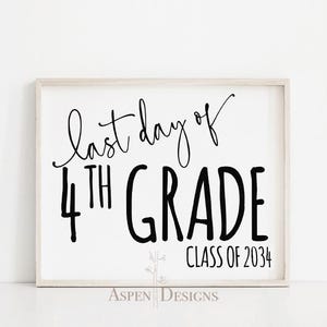 May include: A framed white sign with black script that reads "last day of 4th grade" and "Class of 2034". The sign has a light wood frame and a simple, elegant design, perfect for a classroom or home.