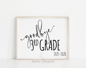 May include: A framed print with the words "goodbye 3rd grade" in black script and block letters. The year range 2025-2026 is below the grade level. The print is in a light-colored wooden frame.