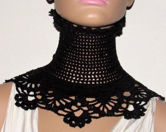 May include: Black crocheted collar necklace with a delicate lace design. The collar is made of a fine, open-weave fabric and has a high, stand-up style.