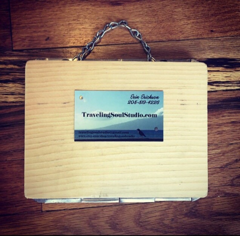 May include: A wooden box with a metal chain handle. The box has a business card attached to it that reads "Erin Erickson, TravelingSoulStudio.com, 206-319-4226, travelingsoulstudio@gmail.com, etsy.com/shop/travelingSoulStudio".