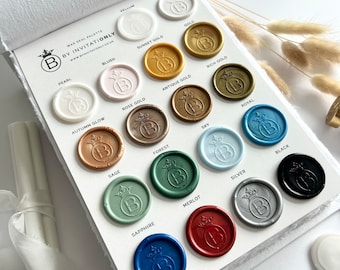 May include: Wax seal palette with 16 different colors, including gold, silver, black, red, blue, green, and brown. Each color is labeled with its name.