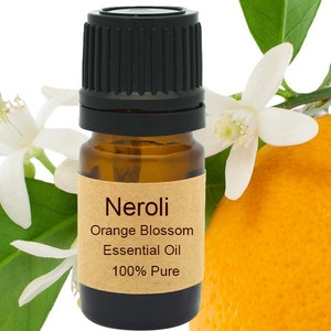 May include: A small brown glass bottle with a black cap, labelled "Neroli Orange Blossom Essential Oil 100% Pure". The bottle is next to a white orange blossom and a partially visible orange.