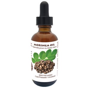 May include: A brown glass bottle with a dropper top filled with Moringa Oil. The label reads "Moringa Oil" and "Organically grown by Mother Nature". The label also includes a picture of Moringa leaves and seeds. The text "Wild Harvested Cold Pressed / Unrefined" is at the bottom of the label.