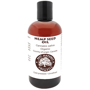May include: A brown glass bottle of hemp seed oil with a black cap. The label reads "HEMP SEED OIL" and "Cannabis sativa Organic". The bottle is from "BEST NATURE'S COSMETIC" and is cold pressed and unrefined.