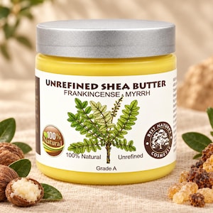 May include: A yellow jar of unrefined shea butter with frankincense and myrrh. The white label features a green plant illustration, text reading 100% Natural, Unrefined, Grade A, and a Best Nature's Cosmetic logo. The jar has a silver lid.