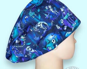 May include: A blue and purple scrub hat with a Halloween-themed print featuring characters from the Nightmare Before Christmas. The print includes Jack Skellington, Sally, and Oogie Boogie.