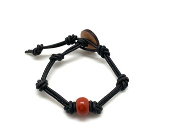 Mens Red Jasper Knotted Leather Bracelet. Adjustable  Wooden button engraved with the OM symbol. Nourishing, Sustaining, Energising