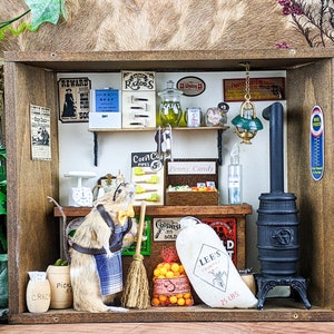 May include: A miniature general store diorama with a rodent shopkeeper. The store features shelves with various products, including soap, pickles, and candy. A black stove and a bag of Lee's Country 25 lbs are also visible.