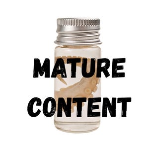 May include: A small, clear glass bottle with a silver cap, containing a preserved specimen. The text "MATURE CONTENT" is printed in bold, black letters across the front of the bottle. The specimen appears to be a portion of an octopus.