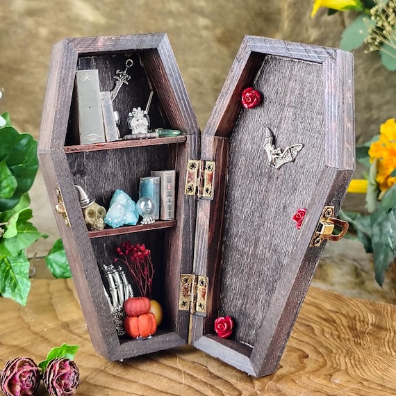 A miniature coffin curio cabinet built for displaying tiny oddities and curiosities — dark academia shelf candy that looks like it belongs in a Victorian apothecary.