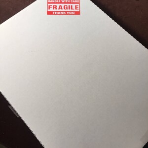 May include: White cardboard box with a red "HANDLE WITH CARE FRAGILE THANK YOU" sticker.