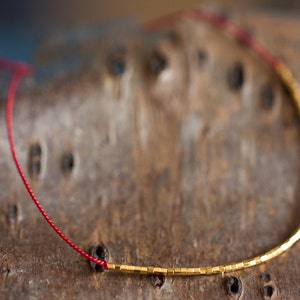 Thinnest beaded friendship bracelet - 24k gold plated beads and red silk cord - Layering bracelet - Thin bridal or bridesmaid gift