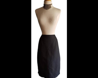 May include: A black pencil skirt on a dress form.