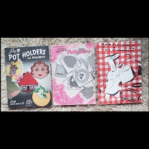 May include: Three vintage books with red and white checkered covers. The books are titled "Lily's Pot Holders and Oven Mitts", "Star Pot Holders", and "Pot Holders".