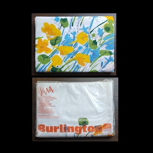 May include: A white twin flat sheet with a floral print in shades of yellow, blue, and green. The sheet is packaged in a clear plastic bag with the text "Burlington" printed in orange.