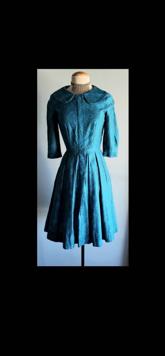 1950s blue and green paisley fit and flair dress.