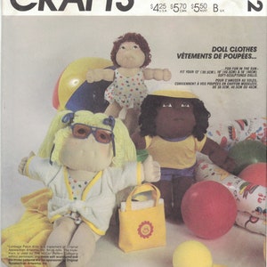 May include: A sewing pattern for doll clothes, featuring a Cabbage Patch Kid doll wearing a white robe and sunglasses. The pattern is for 30.5cm, 40.5cm, and 45cm dolls. The pattern includes a beach bag and a swimsuit. The pattern is called "Doll Clothes for Fun in the Sun."