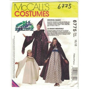 May include: McCall's Costumes sewing pattern 6775 for Medieval Magic costumes. The pattern includes three costumes: a purple and black gown with a pointed hat, a white gown with gold trim, and a red hooded cloak with a floral print dress. The pattern is for sizes 10-12.