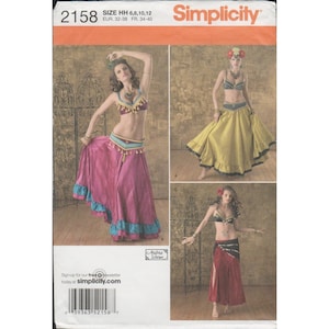 May include: Simplicity sewing pattern 2158 for belly dance costumes. The pattern features three different costume designs with colorful skirts, tops, and decorative embellishments. The pattern includes sizes HH 6, 8, 10, and 12.