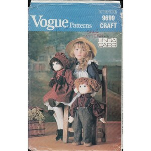 May include: A vintage Vogue Patterns craft pattern, featuring a cover image with three handmade dolls and a young girl. The dolls are dressed in period clothing, with one wearing a red hooded cloak. The pattern is designed by Linda Carr.