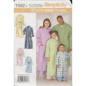 May include: Simplicity sewing pattern 1562A for robes in sizes XS-XL. The envelope features illustrations of yellow, navy, pink, and light blue robes, and a photograph of people wearing a solid lavender, green polka dot, and blue diamond robe.