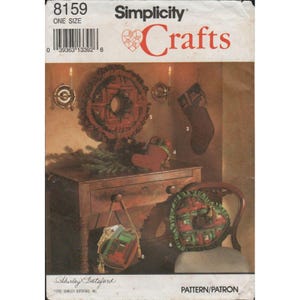 May include: Simplicity Crafts pattern for Christmas decorations. The image shows a wreath, stocking, heart-shaped pillow, and other holiday crafts. The pattern is labeled "8159" and "ONE SIZE".