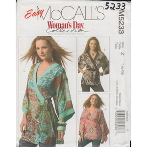 May include: McCall's sewing pattern M5233 featuring three different wrap top designs. The pattern includes sizes Lrg-Xlg. The cover displays color photos of the tops in various paisley and floral prints, with the "Woman's Day Collection" logo.