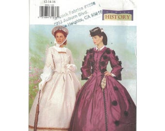 May include: Butterick sewing pattern 6694 featuring two Victorian era dresses. One dress is a striped cream color, and the other is a deep purple with black accents. The pattern includes sizes 12-14-16.