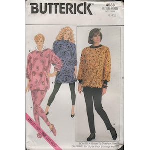 May include: Butterick sewing pattern 4238 featuring three women's outfits. The outfits include a pink paisley top and pants, a blue tunic, and a yellow top with black accents. The text "YES! IT'S EASY!" is visible.