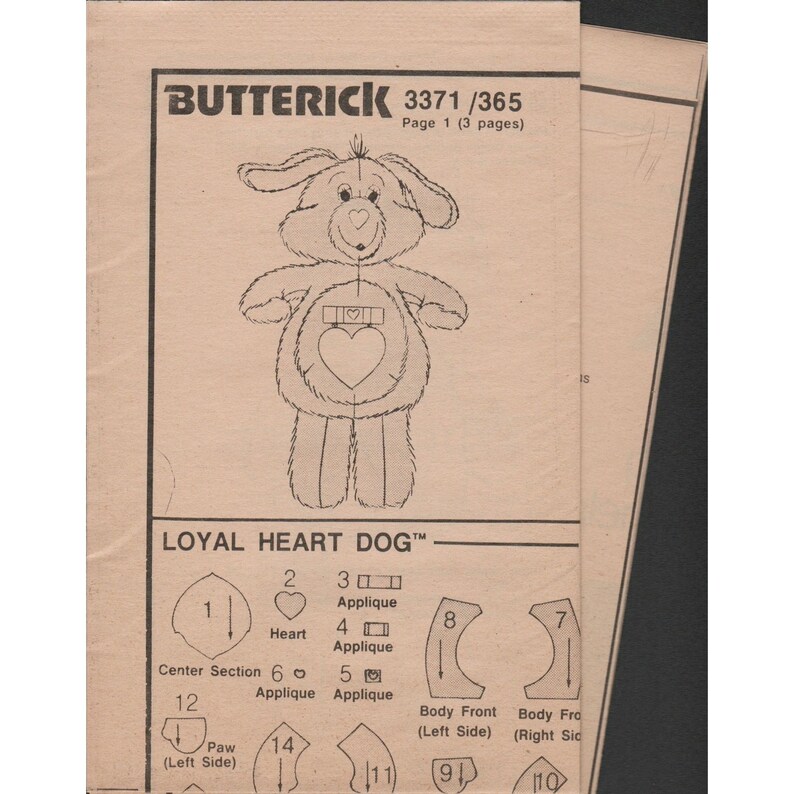 May include: A black and white sewing pattern for a stuffed dog toy. The pattern includes instructions for making the dog's body, head, paws, and a heart applique. The pattern is titled "Loyal Heart Dog&trade;" and is from Butterick pattern number 3371/365.