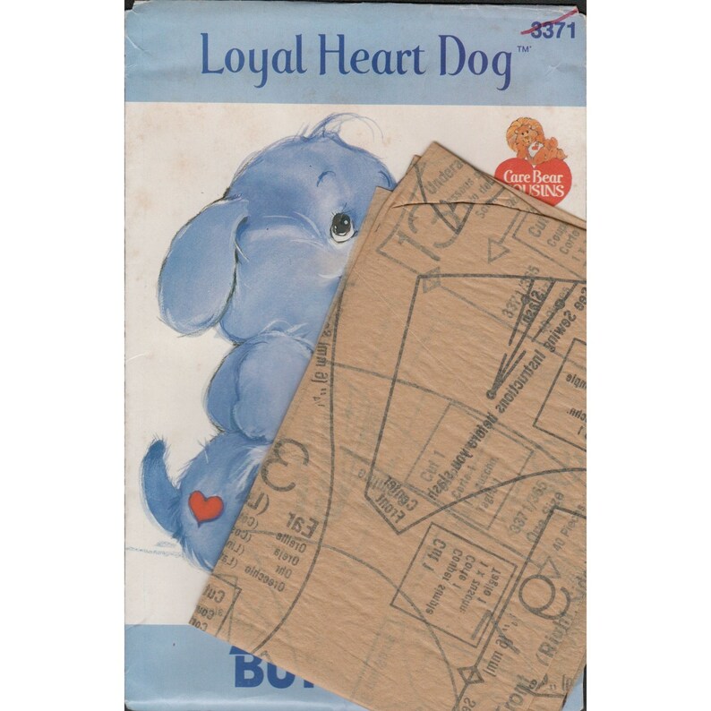 May include: A sewing pattern for a blue Care Bear dog with a red heart on its chest. The pattern is titled "Loyal Heart Dog" and includes instructions for making the toy.