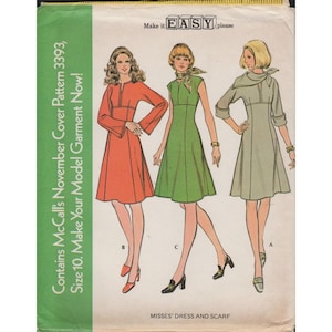 May include: Vintage McCall's sewing pattern cover featuring illustrations of three dresses in orange, green, and gray. The cover text reads "Contains McCall's November Cover Pattern 3393, Size 10. Make Your Model Garment Now!" and "Misses' Dress and Scarf."