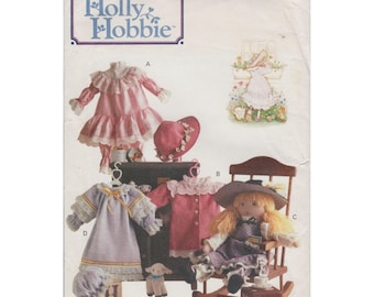 May include: A vintage sewing pattern for making doll clothes. The pattern is for a doll dress, a doll coat, and a doll hat. The pattern is from Butterick and is number 5084. The pattern is for one size.