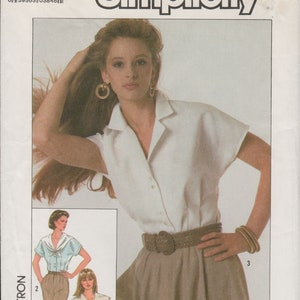 May include: Simplicity sewing pattern number 8499, size H (6+8+10), EUR. H(34+36+38). The pattern includes instructions for making a white blouse with a collar and short sleeves, and a brown skirt with a wide belt.
