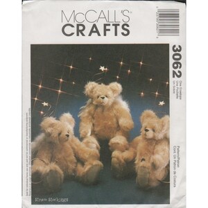 May include: A McCall's Crafts sewing pattern envelope for Straw Stockings, numbered 3062. The front features a photograph of three light brown, fuzzy teddy bears sitting against a dark background with small white star-shaped lights.