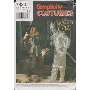 May include: Simplicity Costumes pattern featuring The Wizard of Oz. The cover shows a Scarecrow in a green jacket and brown pants, and a Tin Man in a silver suit. The pattern includes sizes XS, S, M, L, and XL.