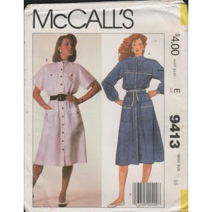 May include: McCall's sewing pattern featuring two button-down dresses. One dress is light pink with short sleeves and a black belt. The other is a long-sleeved denim dress with a white belt and trim. The pattern number is 9413.