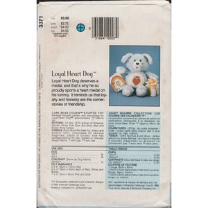 May include: A blue and white stuffed toy dog with a red heart on its chest. The dog is wearing a blue collar with a tag that says "My Friend". The dog is sitting on a white box with a red ribbon. The text "Loyal Heart Dog&trade;" is printed on the back of the package. The package also includes instructions for making the toy.