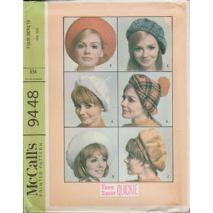 May include: Vintage McCall's pattern for four berets. The pattern features images of women wearing different beret styles, including a red, plaid, and white beret. The pattern includes the text "FOUR BERETS" and "ONE SIZE".