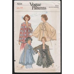 May include: Vogue Patterns 9224 size 14 sewing pattern envelope featuring illustrations of four different jacket and cape styles. The designs include a floral print jacket, a solid beige cape with a tie neck, a light blue cape, and a black lace jacket.