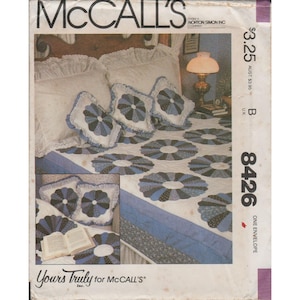 May include: A McCall's pattern envelope featuring a bedspread and pillow set with a blue and white floral design. The envelope displays the pattern number 8426 and the text "Yours Truly for McCall's".