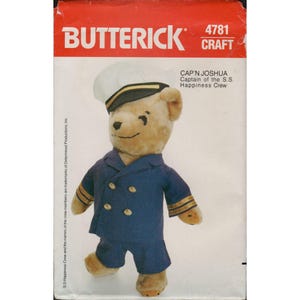 May include: A plush teddy bear wearing a navy blue sailor suit and hat. The bear is labeled "CAP'N JOSHUA Captain of the S.S. Happiness Crew" on the packaging. The Butterick craft pattern is labeled 4781.