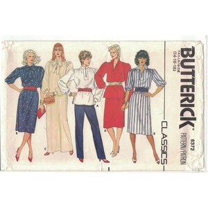 May include: A vintage sewing pattern for women's blouses and dresses. The pattern is from Butterick and has the number 6372. The pattern includes four different styles, all with long sleeves and a variety of necklines. The pattern is for sizes 14-16-18.
