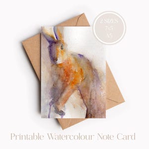 Peut inclure: Carte de vœux aquarelle imprimable représentant un lapin brun peint à l'aquarelle avec des nuances de violet et d'orange. La carte est disponible en deux tailles : 7x5 et A5.