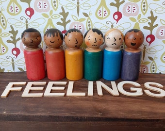 Feelings Wooden peg dolls in multicultural and rainbow colours with 6 different emotions.  For emotional development and loose parts play.