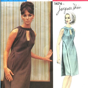 May include: Vogue Paris Original sewing pattern. The image shows a brown dress with a keyhole neckline and a drawing of a light blue dress. The text "VOGUE PARIS ORIGINAL" is at the top of the pattern.
