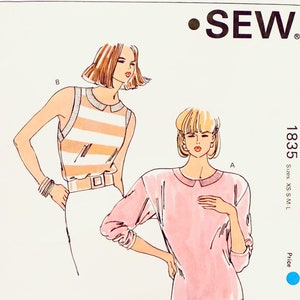 May include: A sewing pattern for two tops, one with a striped design and the other a solid pink colour. The pattern is from Kwik Sew Pattern Co., Inc. and is for sizes XS-S-M-L.